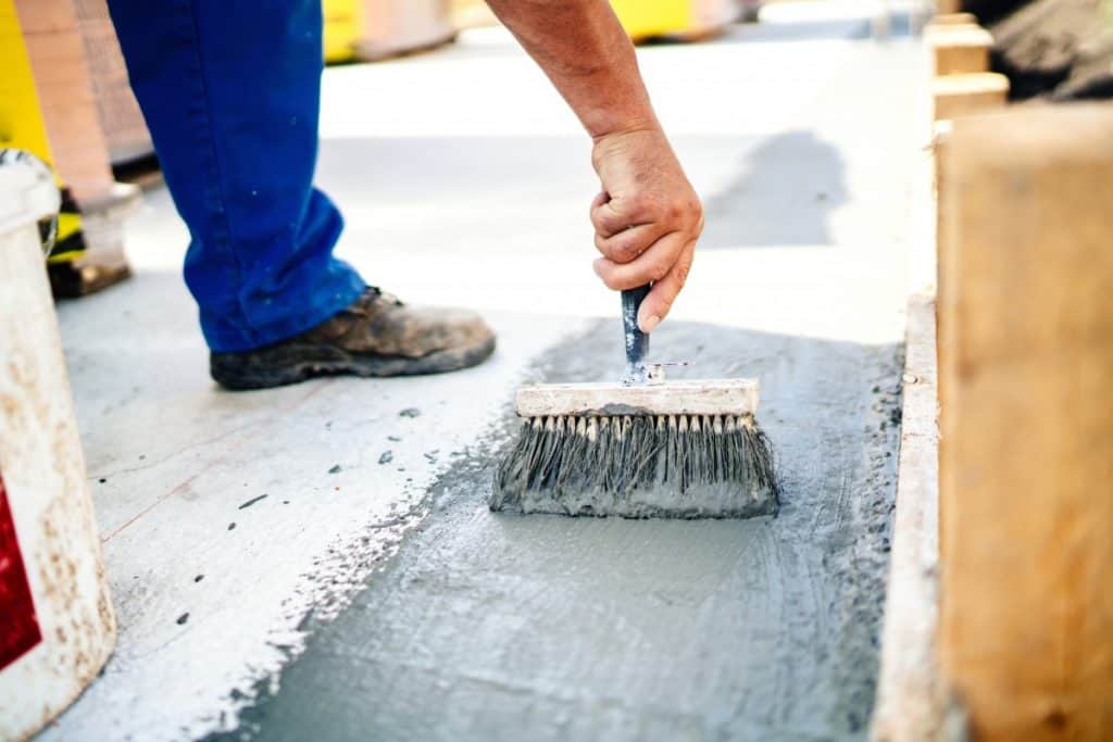 Applying concrete sealer with a brush