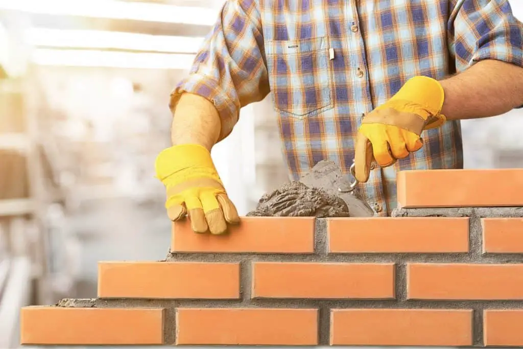 Using mortar when laying bricks