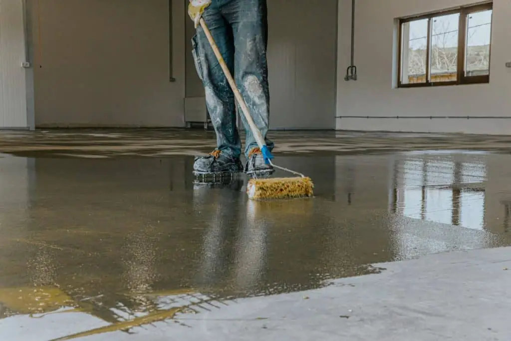 Man sealing concrete floor