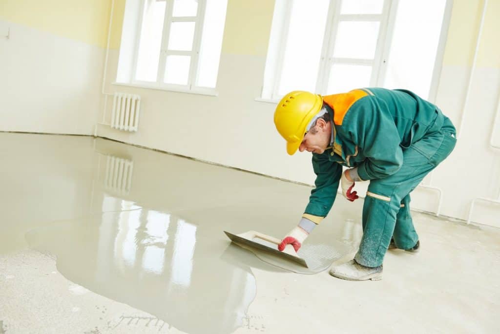 Concrete worker fixing floor