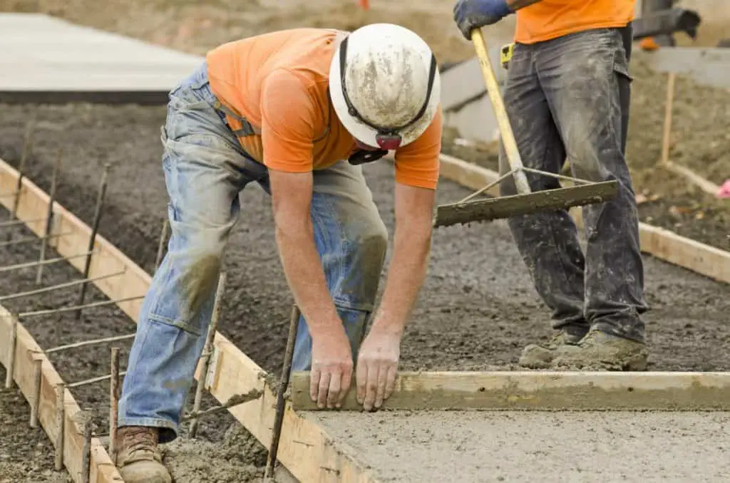 Man works with concrete in forms