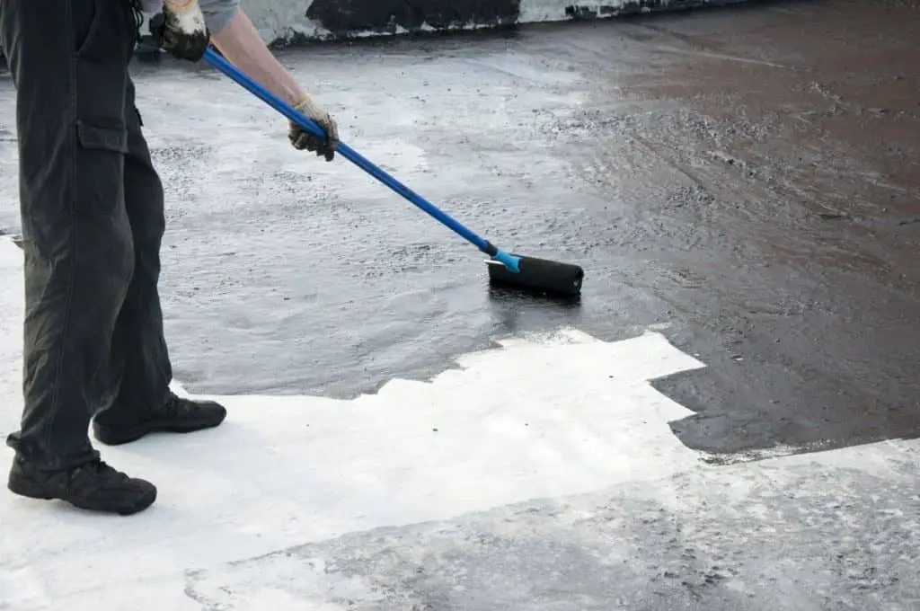 Man painting concete floor