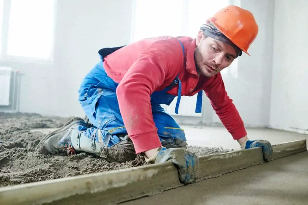 Concrete worker installing concrete floor