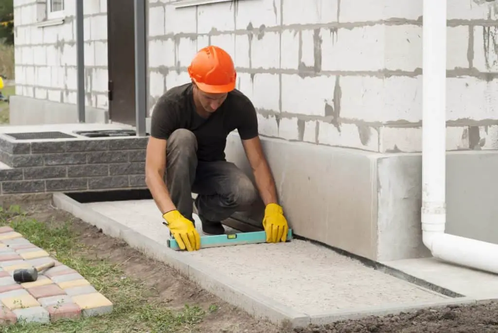 Man works on concrete house