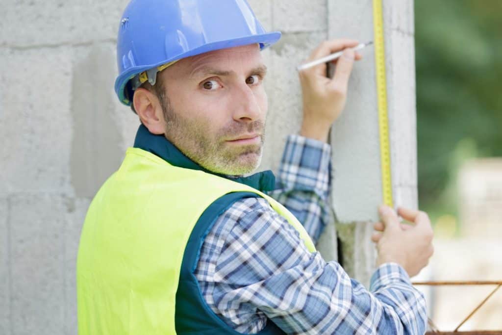 Contractor calculating how much concrete is needed for the job.