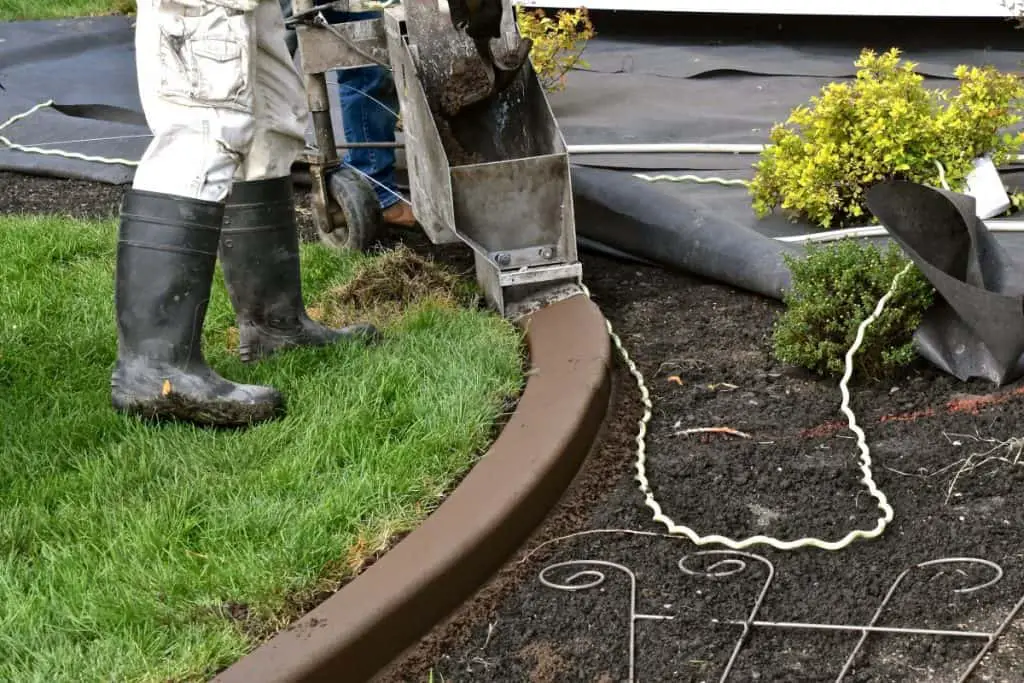 Man installing concrete edging