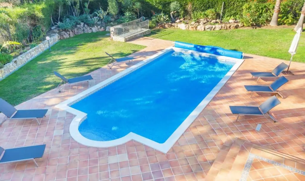 Pool decking with a simple and classy mix of smooth concrete and stamped concrete.