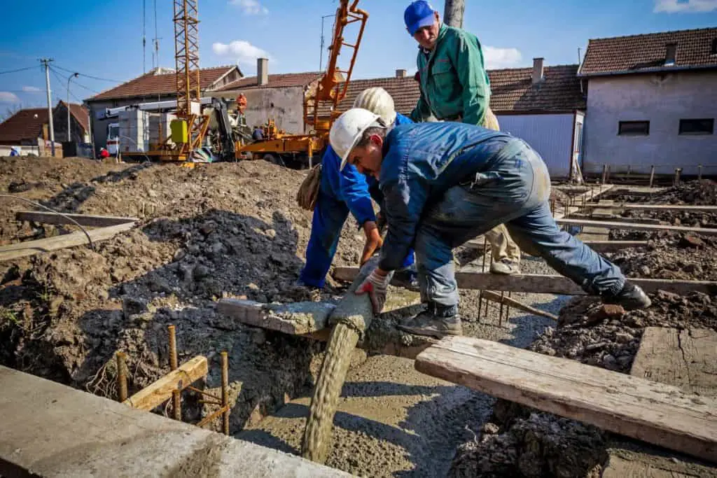 Contractors pouring a concrete foundation 