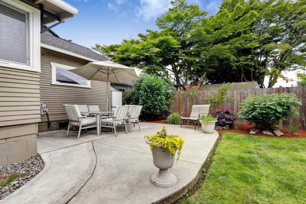 Concrete patio that is higher than the grass