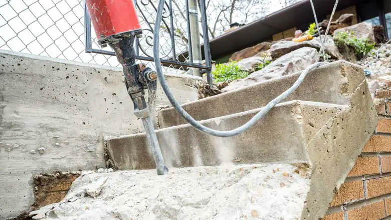 Breaking up concrete steps with a jackhammer