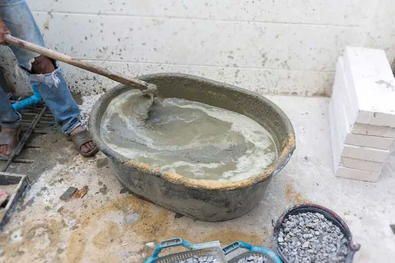 Too much water added in a concrete mix making the concrete too wet.