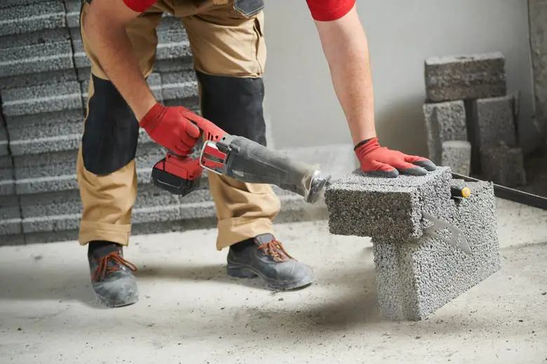 Man cutting concrete with a sawzall